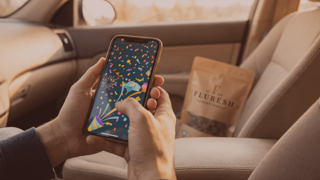 Customer earning Fluresh Rewards points on smartphone with cannabis order bag at curbside pickup